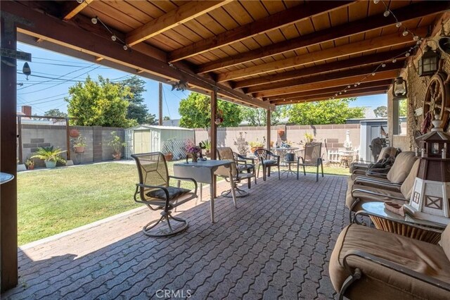12653 Vandemere St, Lakewood, CA 90715 - view of patio featuring a storage shed, outdoor dining space, and an outbuilding