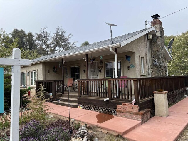 2466 Lupine Dr, Campo, CA 91906 - ranch-style home with a porch, stucco siding, and a chimney