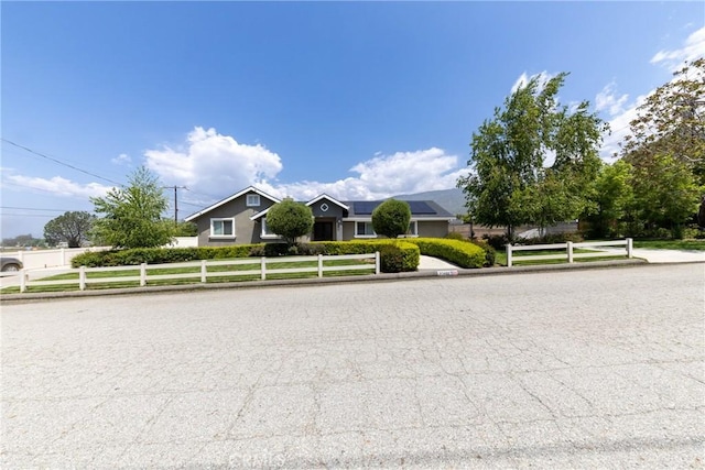 35602 Carter St, Yucaipa, CA 92399 - view of front of home with a fenced front yard and roof mounted solar panels