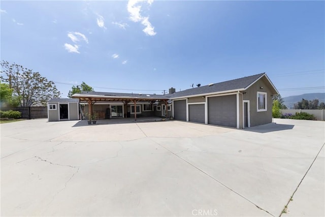 35602 Carter St, Yucaipa, CA 92399 - ranch-style home with driveway, fence, an attached garage, an outdoor structure, and a storage shed