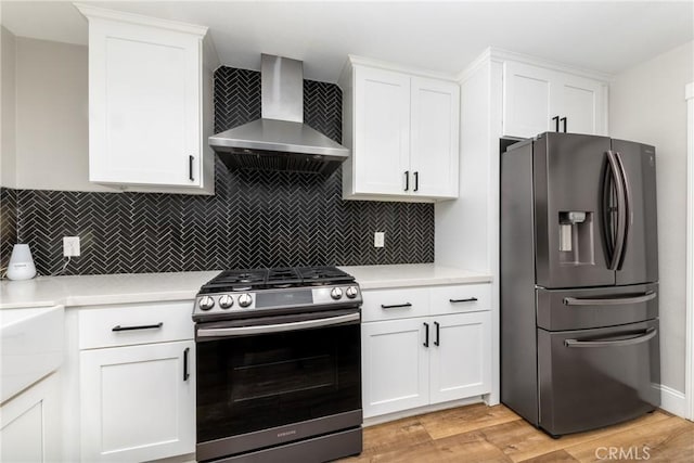 35602 Carter St, Yucaipa, CA 92399 - kitchen with appliances with stainless steel finishes, wall chimney range hood, light countertops, and white cabinets