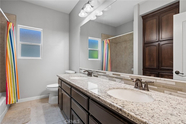 full bath with tasteful backsplash, toilet, baseboards, double vanity, and tile patterned flooring