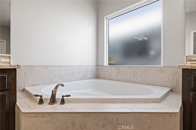 full bathroom featuring vanity and a bath