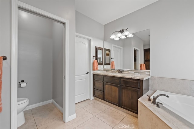 full bathroom with toilet, vanity, a bath, and tile patterned flooring
