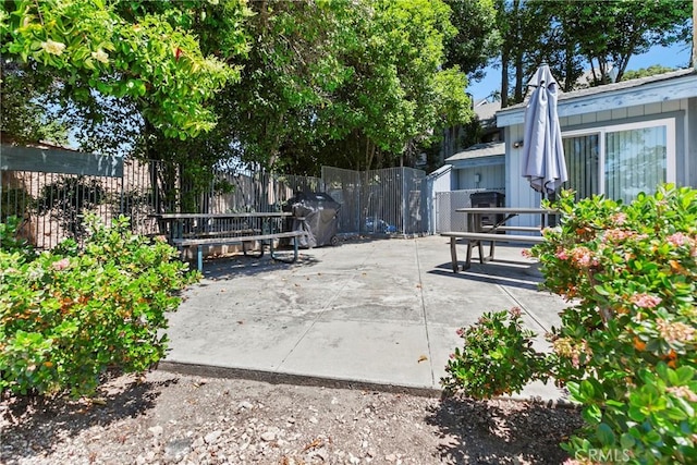 view of community featuring a patio area and fence