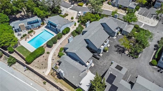 aerial perspective of suburban area featuring a pool