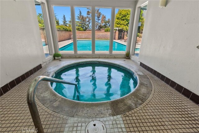 indoor pool featuring a fenced backyard