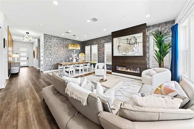 27 Alessio, Lake Forest, CA 92630 - living room with wallpapered walls, wood finished floors, a large fireplace, recessed lighting, and an accent wall