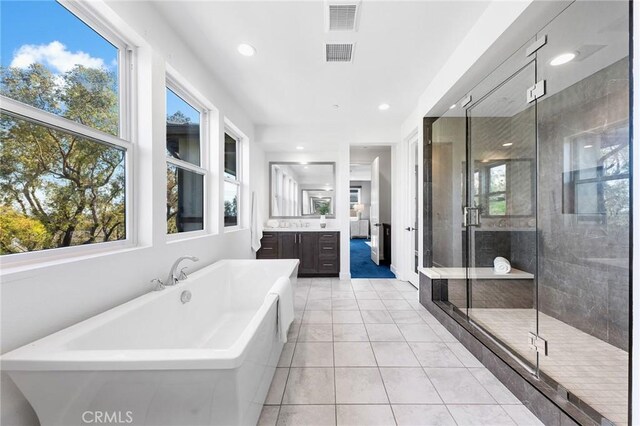 27 Alessio, Lake Forest, CA 92630 - full bathroom featuring a freestanding tub, vanity, tile patterned floors, a stall shower, and recessed lighting