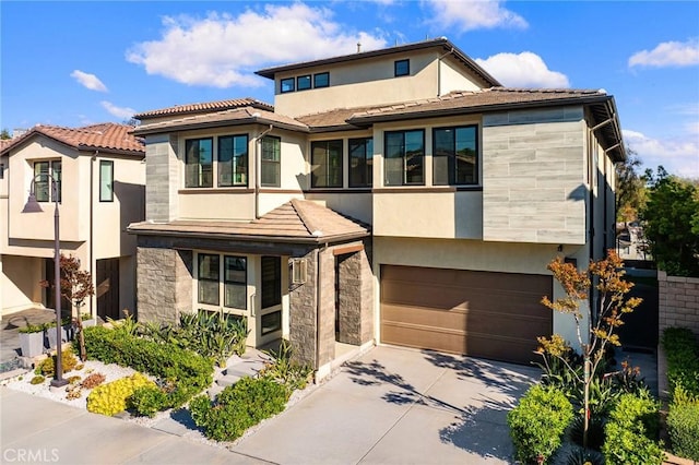 27 Alessio, Lake Forest, CA 92630 - view of front of property with stone siding, stucco siding, an attached garage, and concrete driveway