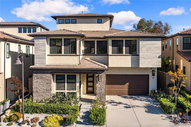27 Alessio, Lake Forest, CA 92630 - view of front of house with stone siding, a garage, stucco siding, and concrete driveway