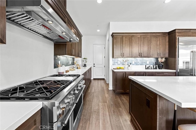 27 Alessio, Lake Forest, CA 92630 - kitchen with premium appliances, ventilation hood, light countertops, wood finished floors, and recessed lighting