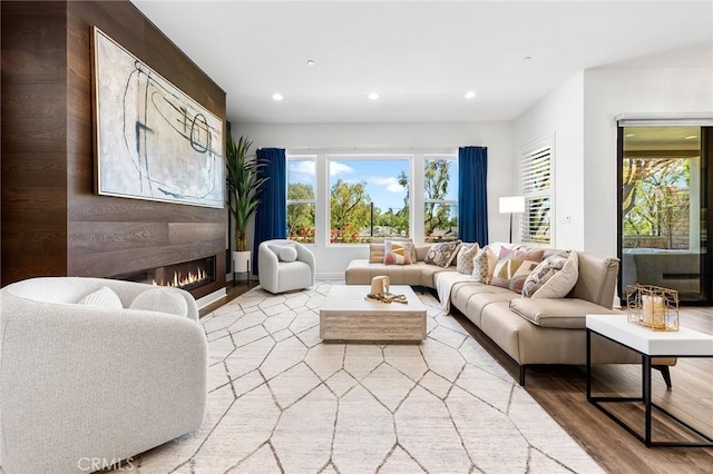 27 Alessio, Lake Forest, CA 92630 - living room featuring light wood-type flooring, a glass covered fireplace, healthy amount of natural light, and recessed lighting