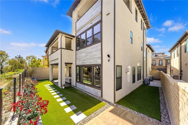 27 Alessio, Lake Forest, CA 92630 - rear view of property featuring stucco siding, a balcony, and cooling unit