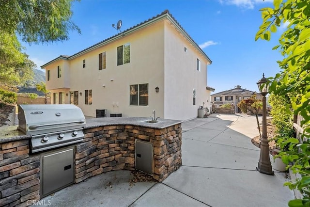 975 Manor Way, Corona, CA 92882 - view of patio / terrace featuring a grill, exterior kitchen, a sink, and fence