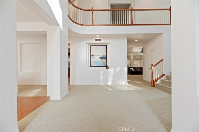 975 Manor Way, Corona, CA 92882 - entryway featuring carpet flooring, a towering ceiling, stairs, a ceiling fan, and baseboards
