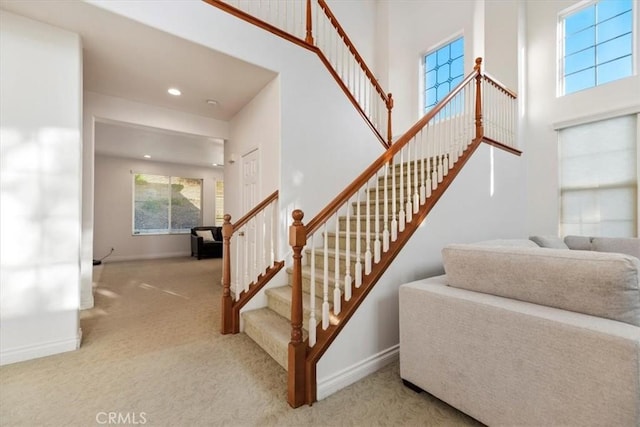 975 Manor Way, Corona, CA 92882 - stairway featuring carpet flooring, healthy amount of natural light, baseboards, recessed lighting, and a towering ceiling