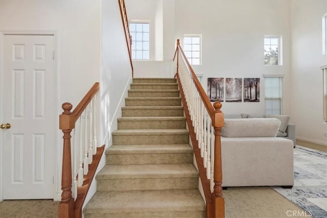 975 Manor Way, Corona, CA 92882 - staircase with a high ceiling, plenty of natural light, baseboards, and carpet