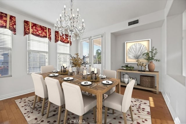 975 Manor Way, Corona, CA 92882 - dining area with a chandelier, light wood-style floors, and baseboards