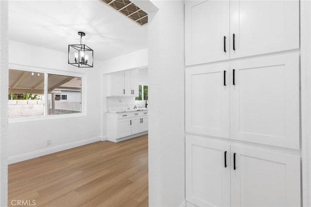 3882 Taft St, Riverside, CA 92503 - detailed view of wood finished floors, baseboards, and a chandelier