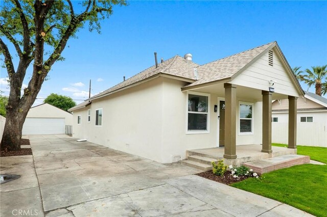3882 Taft St, Riverside, CA 92503 - view of front of property with a shingled roof, stucco siding, a garage, a porch, and an outdoor structure