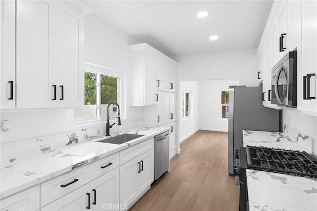 3882 Taft St, Riverside, CA 92503 - kitchen featuring a sink, stainless steel appliances, white cabinetry, light wood finished floors, and recessed lighting