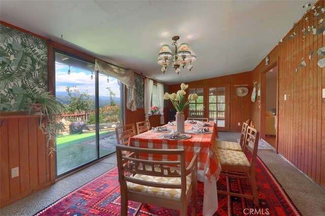 44800 Ahwahnee Acres Rd, Ahwahnee, CA 93601 - carpeted dining space featuring a chandelier and wood walls