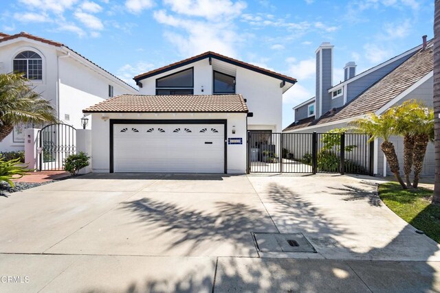 3960 W Hemlock St, Oxnard, CA 93035 - view of front of property with a gate, concrete driveway, stucco siding, and a tile roof