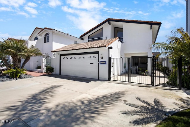 3960 W Hemlock St, Oxnard, CA 93035 - mediterranean / spanish house with a gate, stucco siding, a tile roof, driveway, and fence