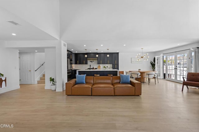 3960 W Hemlock St, Oxnard, CA 93035 - living area featuring light wood-style flooring, recessed lighting, stairway, a chandelier, and french doors