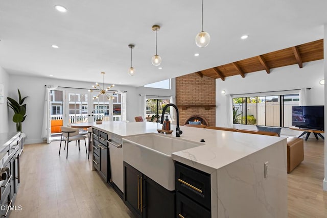3960 W Hemlock St, Oxnard, CA 93035 - kitchen with open floor plan, a sink, light wood-style floors, a fireplace, and recessed lighting