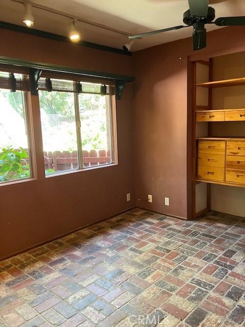 9656 Green Verdugo Dr, Shadow Hills, CA 91040 - empty room with a ceiling fan and brick floors