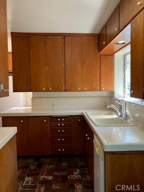 9656 Green Verdugo Dr, Shadow Hills, CA 91040 - kitchen featuring a sink, light countertops, and brown cabinetry