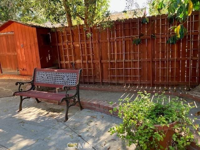 9656 Green Verdugo Dr, Shadow Hills, CA 91040 - surrounding community with fence, a patio, an outdoor structure, and a storage shed