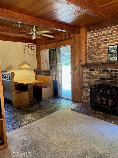 9656 Green Verdugo Dr, Shadow Hills, CA 91040 - kitchen featuring wood ceiling, beamed ceiling, carpet, ceiling fan, and wooden walls