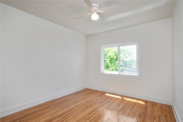 827 S Leland St, San Pedro, CA 90731 - unfurnished room with light wood-type flooring, baseboards, a textured ceiling, and a ceiling fan