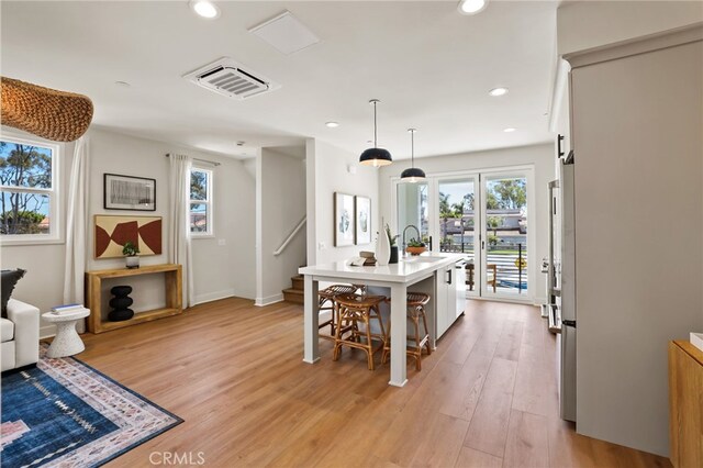19041 Main St Unit 109, Huntington Beach, CA 92648 - kitchen with healthy amount of natural light, light countertops, a sink, a breakfast bar, and recessed lighting