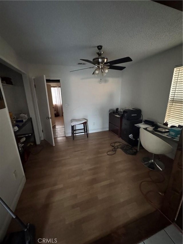 4521 Southern Breeze Dr, Bakersfield, CA 93313 - home office with ceiling fan, wood finished floors, and a textured ceiling