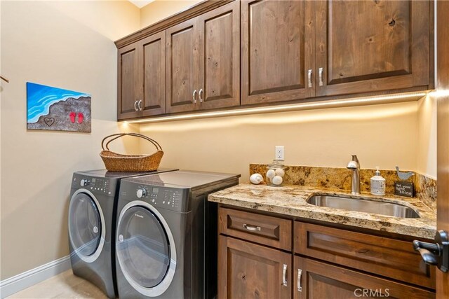 2815 Rock Wren Ln, Avila Beach, CA 93424 - laundry area with cabinet space, washer and clothes dryer, baseboards, and light tile patterned floors