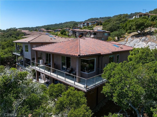 2815 Rock Wren Ln, Avila Beach, CA 93424 - back of property featuring a tiled roof, stucco siding, and a balcony