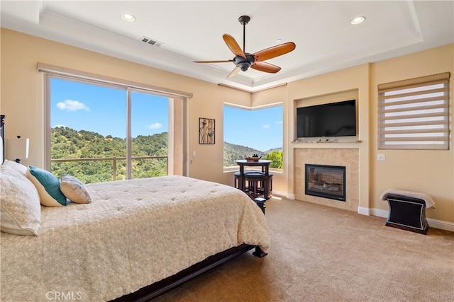2815 Rock Wren Ln, Avila Beach, CA 93424 - carpeted bedroom featuring a raised ceiling, a glass covered fireplace, recessed lighting, baseboards, and a ceiling fan