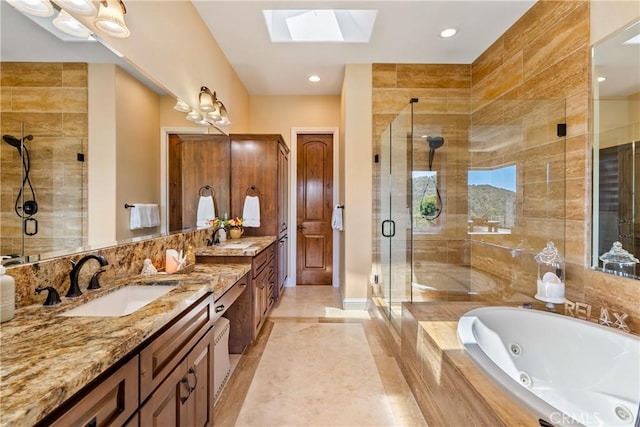 2815 Rock Wren Ln, Avila Beach, CA 93424 - bathroom with a skylight, a shower stall, a tub with jets, double vanity, and baseboards