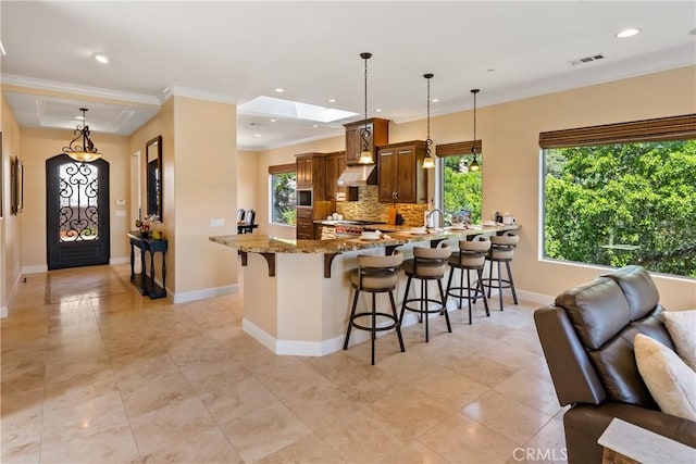 2815 Rock Wren Ln, Avila Beach, CA 93424 - kitchen featuring a breakfast bar area, light stone countertops, open floor plan, a peninsula, and recessed lighting