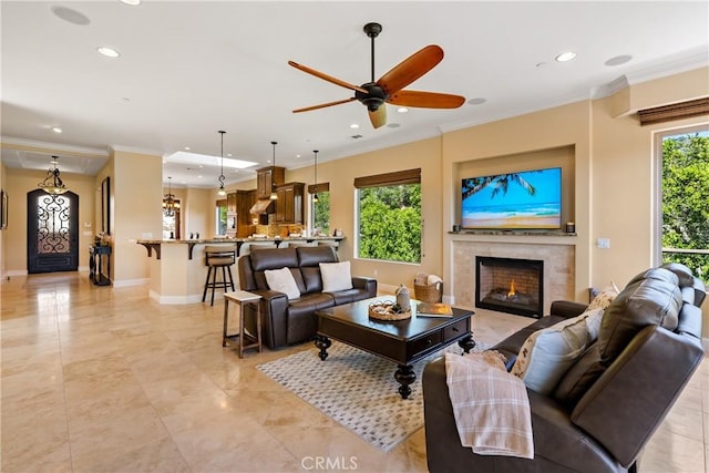 2815 Rock Wren Ln, Avila Beach, CA 93424 - living area with recessed lighting, a warm lit fireplace, ornamental molding, ceiling fan, and baseboards