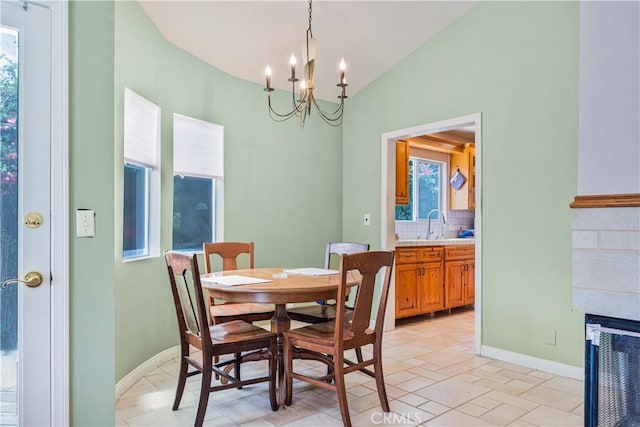 22532 Dolorosa St, Woodland Hills, CA 91367 - dining room featuring a chandelier, lofted ceiling, plenty of natural light, a fireplace, and baseboards