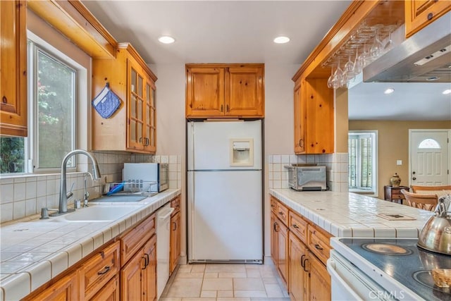 22532 Dolorosa St, Woodland Hills, CA 91367 - kitchen featuring white appliances, a sink, tasteful backsplash, brown cabinets, and glass insert cabinets