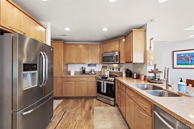 27812 Violet Unit 140, Mission Viejo, CA 92691 - kitchen with appliances with stainless steel finishes, light wood finished floors, light stone countertops, and recessed lighting