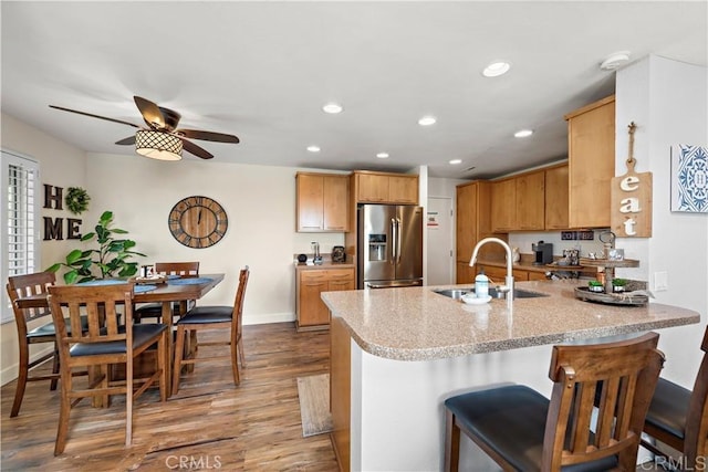 27812 Violet Unit 140, Mission Viejo, CA 92691 - kitchen with stainless steel fridge with ice dispenser, a sink, a peninsula, wood finished floors, and baseboards