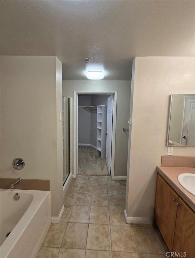 2742 Cabrillo Ave Unit 201, Torrance, CA 90501 - full bathroom with baseboards, vanity, a bath, and a walk in closet
