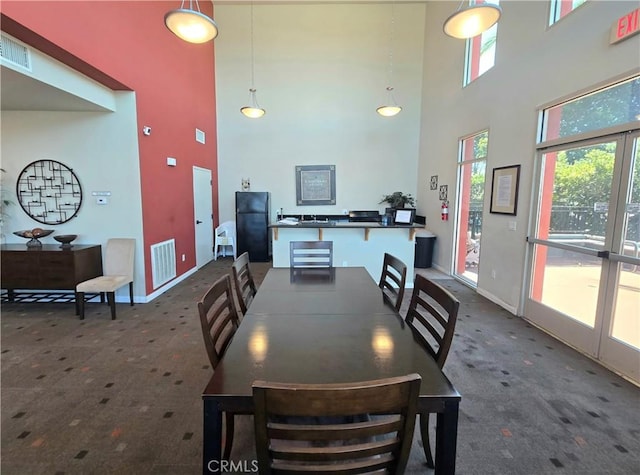 2742 Cabrillo Ave Unit 201, Torrance, CA 90501 - dining area featuring carpet floors, a towering ceiling, and baseboards